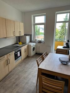 a kitchen with a dining table and a kitchen with a tableablish at Ferienwohnung Augustus in Bremerhaven
