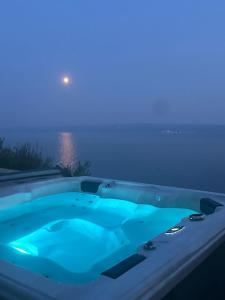 a jacuzzi tub with blue lights in the sky at Super Horizont beach house-FREE PARKING AND JACCUZZI in Split