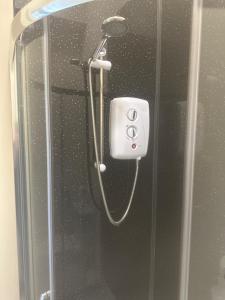 a shower in a bathroom with a glass door at The New Brighton Hotel in New Brighton