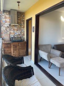 a living room with two chairs and a kitchen at Sonhos da Serra - apartamento 201 - A in Bananeiras +5 photos
