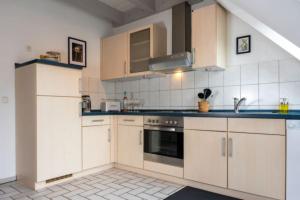 a kitchen with white cabinets and blue counter tops at Alt Mölln, Wohnung 10 in Alt Mölln