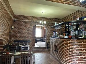 a brick room with a bar and a brick wall at Casa Alex Rasnov in Râşnov +17 photos