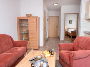 ノルトダイヒにあるApartment Osterriede by Interhomeの赤いソファ2つとテーブルのあるリビングルーム +31枚の写真