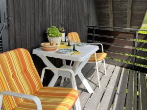 a white table and two chairs on a patio at Apartment Wichtelmännchen by Interhome in Dittishausen