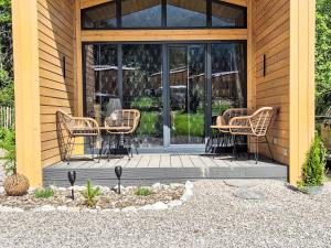 a group of chairs and tables on a porch at Holiday Home Tiny Haus Glockenalm-Chalet Wendelstein by Interhome in Aurach