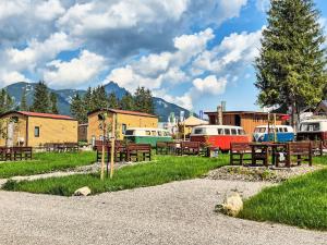 a park with benches and cars parked in a field at Holiday Home Tiny Haus Glockenalm-Chalet Wendelstein by Interhome in Aurach
