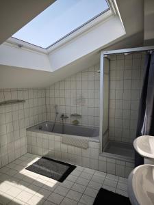 a bathroom with a tub and a sink at Villa Levilia in Strullendorf +13 photos