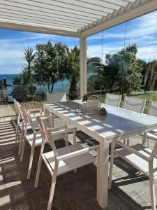 a white table and chairs on a patio at PIPER ETXEA Relax, mar y monte! in Mutriku