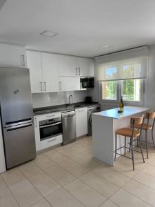 a kitchen with stainless steel appliances and a counter at PIPER ETXEA Relax, mar y monte! in Mutriku