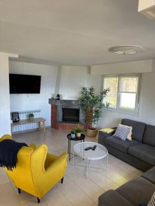 a living room with a couch and a table at PIPER ETXEA Relax, mar y monte! in Mutriku +21 photos