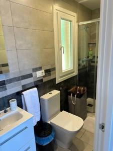a bathroom with a toilet and a sink and a mirror at PIPER ETXEA. Relax, mar y monte! in Mutriku +17 photos