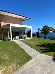 a house with a large glass door on the side of it at PIPER ETXEA. Relax, mar y monte! in Mutriku
