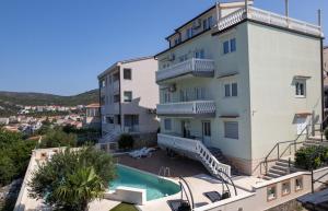 an apartment with a swimming pool and a building at Apartment with Pool "Sunset Cove" in Neum