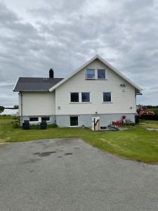 a large white house with a lot of windows at Rural apartment in Dverberg