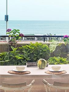 a table with two chairs and a view of the ocean at brise marine plage Hendaye in Hendaye