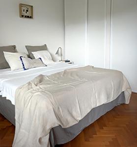 a bedroom with a white bed with white sheets and pillows at brise marine plage Hendaye in Hendaye