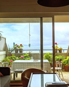 a living room with a table and a view of the ocean at brise marine plage Hendaye in Hendaye +9 photos