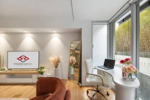 a living room with a desk with a laptop on it at Pacific Chic Luxury Pad - Beachfront Aircon Lift in Sydney +33 photos