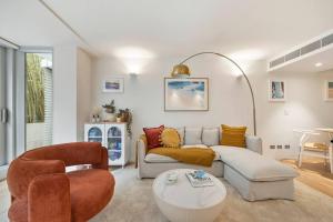 a living room with a couch and a table at Pacific Chic Luxury Pad - Beachfront Aircon Lift in Sydney