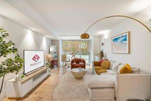 a living room with a couch and a table at Pacific Chic Luxury Pad - Beachfront Aircon Lift in Sydney