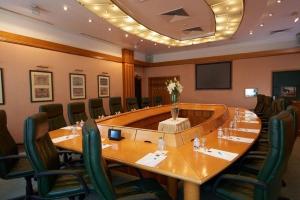 a large meeting room with a large table and chairs at Verdi Budapest Aquincum in Budapest