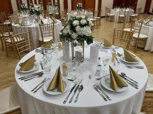a table with plates and napkins on top of it at Verdi Budapest Aquincum in Budapest