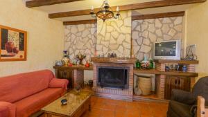 a living room with a couch and a fireplace at La Chumbera Órgiva by Ruralidays in Órgiva