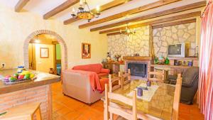 a living room with a couch and a fireplace at La Chumbera Órgiva by Ruralidays in Órgiva
