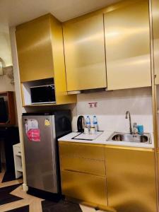 eine Küche mit einem Kühlschrank aus Edelstahl und einer Spüle in der Unterkunft Espana condo resort pattaya by Nongying in Jomtien Beach