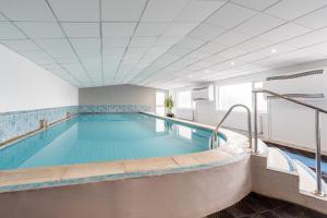 a pool in a building with a swimming pool at The Queens Hotel in Paignton