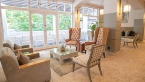 a large living room with chairs and a table at Le Franschhoek Hotel & Spa by Dream Resorts in Franschhoek +175 photos