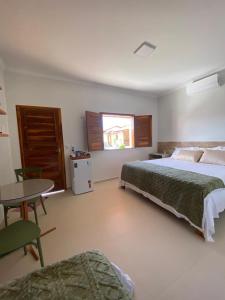 Ένα ή περισσότερα κρεβάτια σε δωμάτιο στο Pousada Villa Chalé