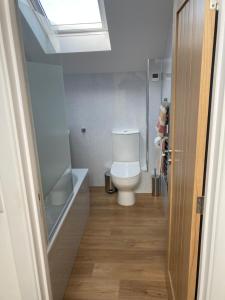 a bathroom with a toilet and a sink and a window at The Boathouse in Mylor Bridge +13 photos