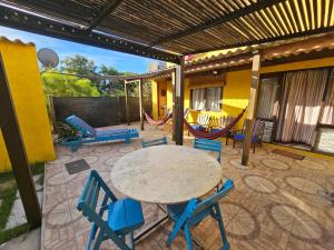 a patio with a table and chairs on a patio at Mirador del Diablo in Punta Del Diablo