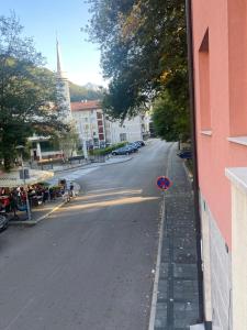 an empty street in a city with a building at Ćiro-Park in Jablanica +11 photos