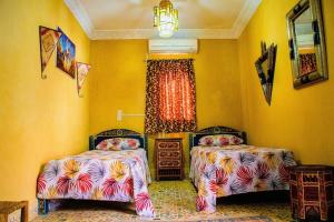 a bedroom with two beds and a window at Riad - In Medina - Kesh Design in Marrakesh
