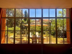 a room with a large window with a table at Les tamaris in La Londe-les-Maures