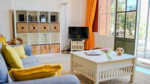 a living room with a couch and a coffee table at Les tamaris in La Londe-les-Maures