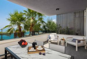 a balcony with a table and a view of the ocean at Paoma Lux Beach Suites in Podstrana