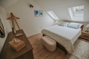 a small bedroom with a bed and a table at Stone House Zrinski entire apartment 62 m2 in Luka