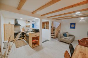 a kitchen and living room with a table and a couch at Stone House Zrinski entire apartment 62 m2 in Luka