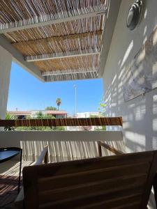 a patio with a table and chairs and a roof at Vistamare Rooftop in San Cataldo