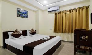 Ένα ή περισσότερα κρεβάτια σε δωμάτιο στο Hotel Midtown Begumpet