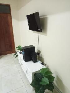 a room with two speakers and a tv on a wall at Ashley's apartment in Bamburi