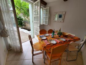 a dining room with a table and chairs and a window at Occ34 - Capestang - Villa Quinlan in Capestang