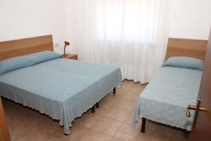 A bed or beds in a room at Villa Mazzon Family Apartments