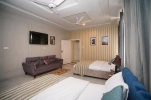 a hotel room with a bed and a couch at Green orchard skardu in Skardu