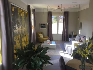 a living room with a white couch and a table at Le Clos Saint André in Banyuls-sur-Mer