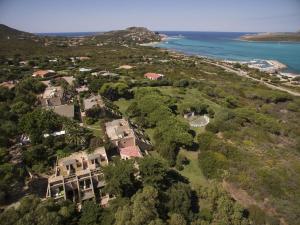 an aerial view of a mansion next to the ocean at UNAHOTELS Club Hotel Ancora in Stintino