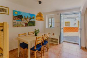 a dining room with a table and chairs at Casa del Patito with Vista by Duckling Stays in Olvera